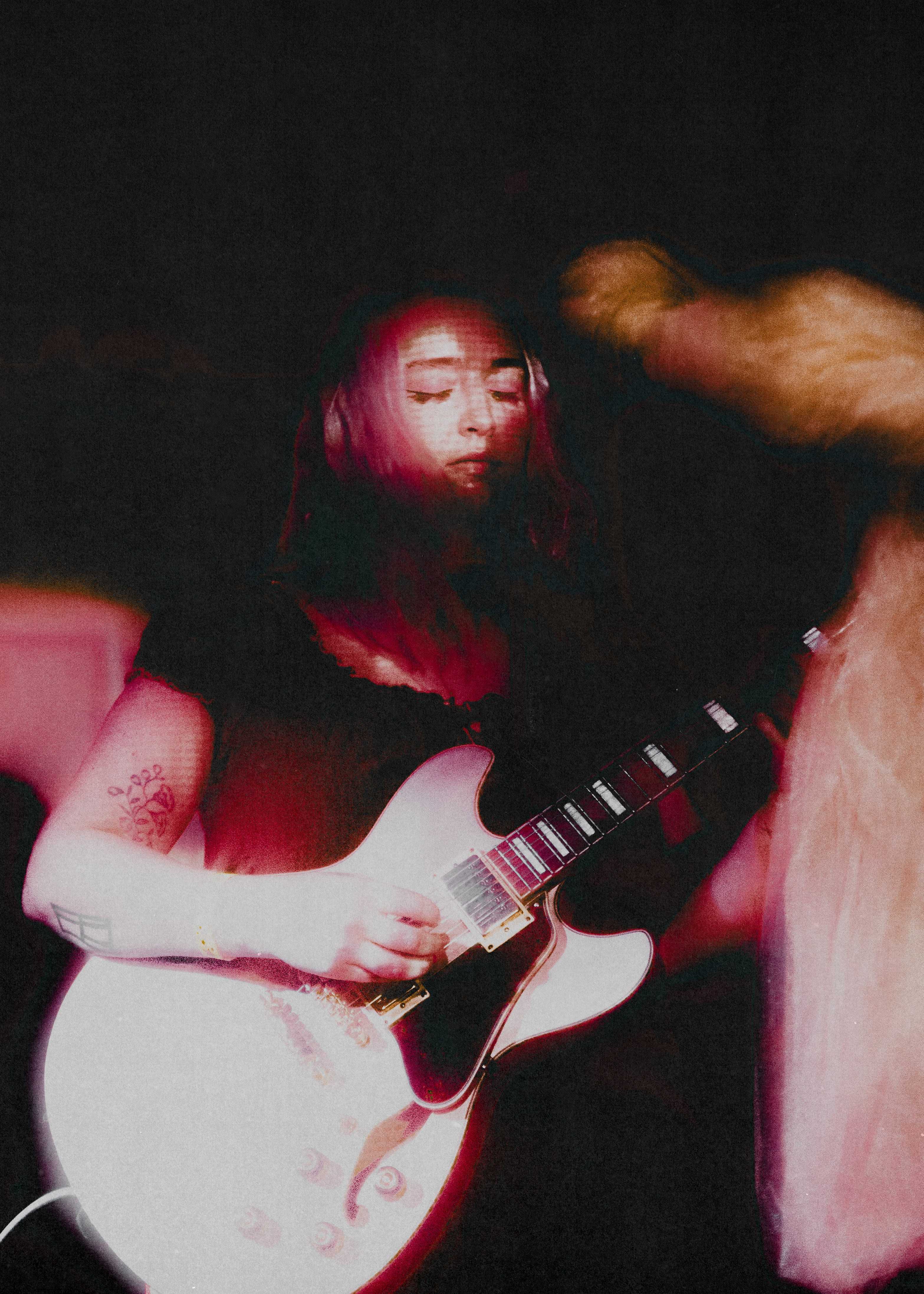 Isadora playing guitar